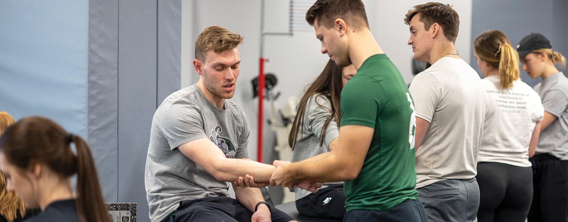 Students using equipment in sport and exercise science lab